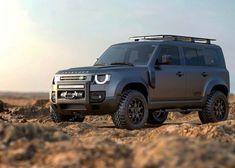 a grey land rover is parked in the desert