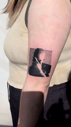 a woman with a black and white photo on her arm