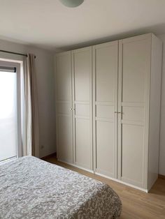 a bedroom with a bed, closet and sliding glass door