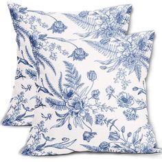 two blue and white pillows with flowers on them