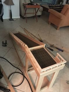 a wooden table sitting on top of a tiled floor