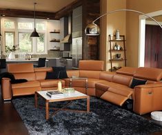 a living room filled with lots of furniture in it's center area and windows