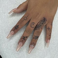 a woman's hand with some tattoos on it