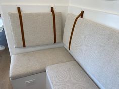 two seats are attached to the back of a boat's seat, which is made out of fabric