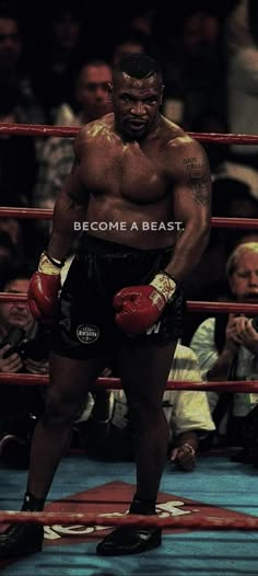 a man standing in the middle of a boxing ring