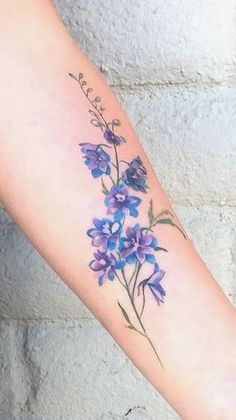 a woman's arm with purple flowers on it