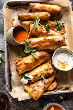 some food is on a tray with dipping sauces