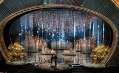 the stage is set for an oscars performance with two people standing on each side