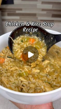 a bowl of chicken and rice soup being spooned into it with a ladle