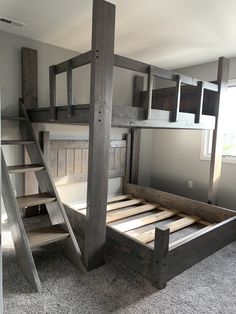 a bunk bed made out of wooden planks with stairs leading up to the top