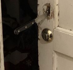 an open door with a metal handle on it's left side and the bottom half missing