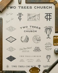 there are many different types of logos on the wall in this church building, including two trees church and two trees church