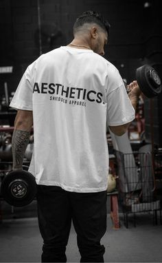 This oversized gym t-shirt is perfect for a relaxed workout. The pump cover provides support and coverage, and the white color is both stylish and versatile. #gym #workout #fitness . #Oversized_Gym_Tee #Gym_T_Shirts_Design #Training_Aesthetic #Marketing_Clothing Oversized Tshirt Outfit Men, Gym Tshirt Design, Minimalist Tshirt Design, Gym Graphic Tees, Marketing Clothing, Gym Tshirt, Oversize Outfit, Gym Tees, Pump Cover