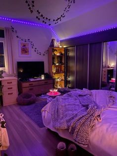 a bed room with a neatly made bed and purple lighting