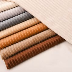 several colors of ribbed fabric laying on top of each other in different sizes and shapes