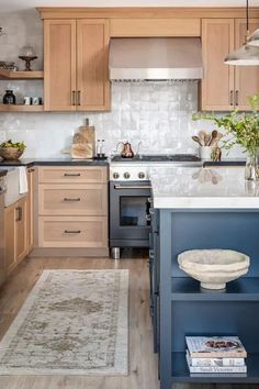 a kitchen with wooden cabinets and blue island