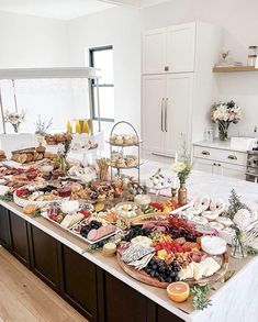 a table filled with lots of food on top of a kitchen counter