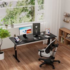 a computer desk with a monitor, keyboard and mouse on it in front of a window