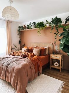 a bed in a bedroom with plants on the headboard and rugs around it