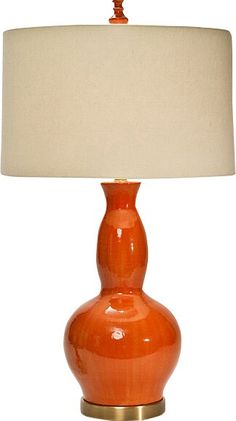 an orange lamp with a white shade on it