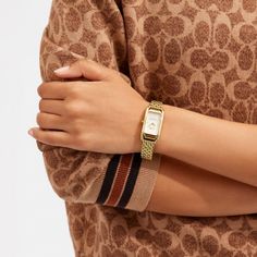 Inspired by the sleek designs of 1920s Art Deco the Cadie watch has an elegant long and lean silhouette. The gold tone bracelet timepiece features a dial detailed with our iconic Horse and Carriage motif. | Coach Cadie Watch, 20 Mm X 32.5 Mm - Women's - Gold