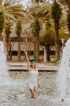 a woman standing in the water with her arms up