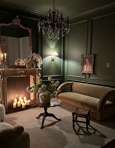 a living room filled with furniture and candles