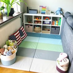 a child's playroom with toys and bookshelves in the corner,