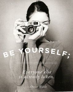 a woman holding up a camera to her face with the words be yourself on it