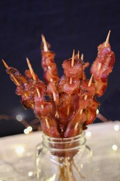 bacon wrapped in toothpicks sitting in a glass jar