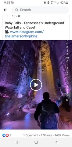 a man is standing in front of a waterfall