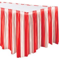 red and white striped table cloths on top of each other in front of a white backdrop