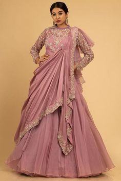 A stunning monotone ensemble to style your look for intimidate wedding party hued in Mauve features a net pleated collared blouse beautified with seamless floral jaal enhanced with sequins and cutdana work paired with a plain organza skirt. The skirt is attached with a draped silk dupatta that falls asymmetrically from the shoulders. There might be a little color variation in the image and original product due to photographic lighting sources or your monitor settings. Dupatta Attached Dresses, Gown With Attached Dupatta, Lehenga For Party, Cutdana Work, Beautiful Lehenga, Wedding Outfits For Women, Western Dresses For Women, Trendy Outfits Indian, Gown Party Wear