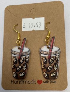 the earrings are decorated with skulls and drinks