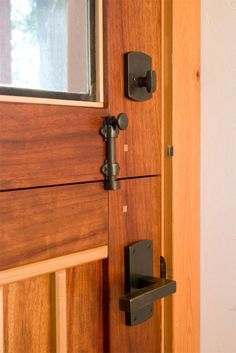 a close up of a door handle on a wooden door