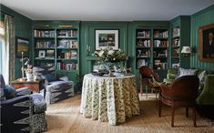 a living room filled with furniture and bookshelves covered in lots of green paint