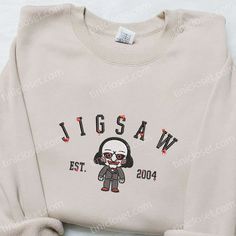 a white sweatshirt with a cartoon character on the front and back, that says wigsaw est 2010