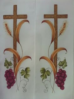 two crosses with grapes and leaves painted on them