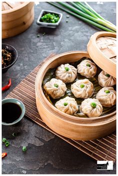 some dumplings are in a wooden container on a table