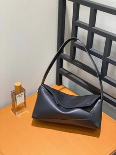 The Puzzle Hobo is made of a soft nappa calfskin inspired by the cuboid shape and distinctive geometric lines of the Puzzle bag. Black Designer Bags, Bag Wishlist, Cuboid Shape, Loewe Puzzle Bag, 2023 Wishlist, Loewe Puzzle, Dream Bags