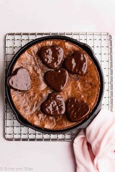 a heart shaped chocolate cake on a cooling rack