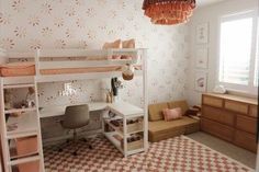 a bedroom with a bunk bed, desk and chair next to a wallpapered wall