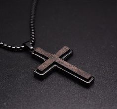 Add a touch of sophistication to your ensemble with our Ebony Wood Cross Necklace for Men. Handmade with care, this black stainless steel Christian pendant features a Real Ebony Wood pendant on a 24-inch chain. It's a symbol of faith and fashion. Highlights: UNUSUAL DESIGN: Wooden Cross Necklace for men using real natural ebony wood with High quality stainless steel. It not only retains the natural essence of the wood cross necklace but also takes into account the strong protection of stainless Black Cross Necklace For Men, Boys Cross Necklace, Wooden Cross Necklace, Cross Necklace Men, Black Cross Necklace, Christian Cross Necklace, Cross Necklace Simple, Cross Necklace For Men, Music Designs