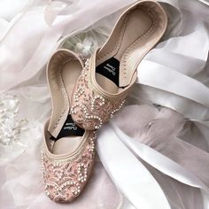 Introducing our exquisite RoseGold Bridal Khussa, a true masterpiece crafted to enhance your special day with elegance and comfort. Meticulously handcrafted with genuine leather and adorned with high-quality silk, these Khussa shoes are the epitome of luxury and style. Each pair is a testament to the artistry of our skilled artisans, featuring intricate cora and beadwork that adds a touch of regal charm. But beauty is not the only aspect we've considered; we've prioritized your comfort as well. Elegant Ballet Flats For Wedding, Elegant Wedding Ballet Flats, Elegant Almond Toe Ballet Flats For Wedding, Pearl Embellished Wedding Flats, Elegant Pink Flats For Wedding, Elegant Pink Wedding Flats, Wedding Ballet Flats With Closed Toe, Pink Wedding Flats With Flat Heel, Embellished Flats For Wedding