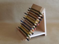 there are many pencils in the holder on the table and one is made out of wood