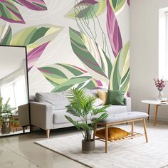 a living room with a couch, mirror and plants on the floor in front of it