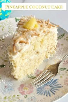 a piece of pineapple coconut cake on a floral plate with a fork next to it