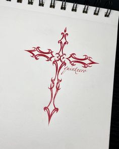 a cross drawn in red ink on white paper