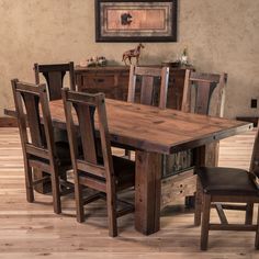 a dining room table and chairs with wooden floors