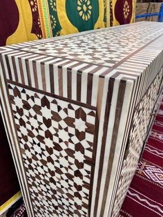 an intricately designed wooden table on display in a store